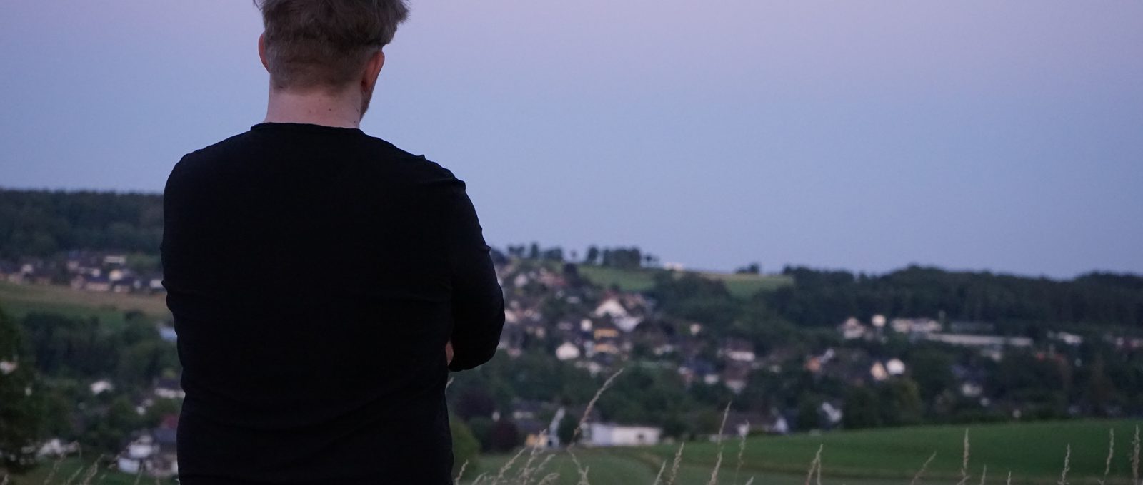 Kevin looking out over his home village at dusk